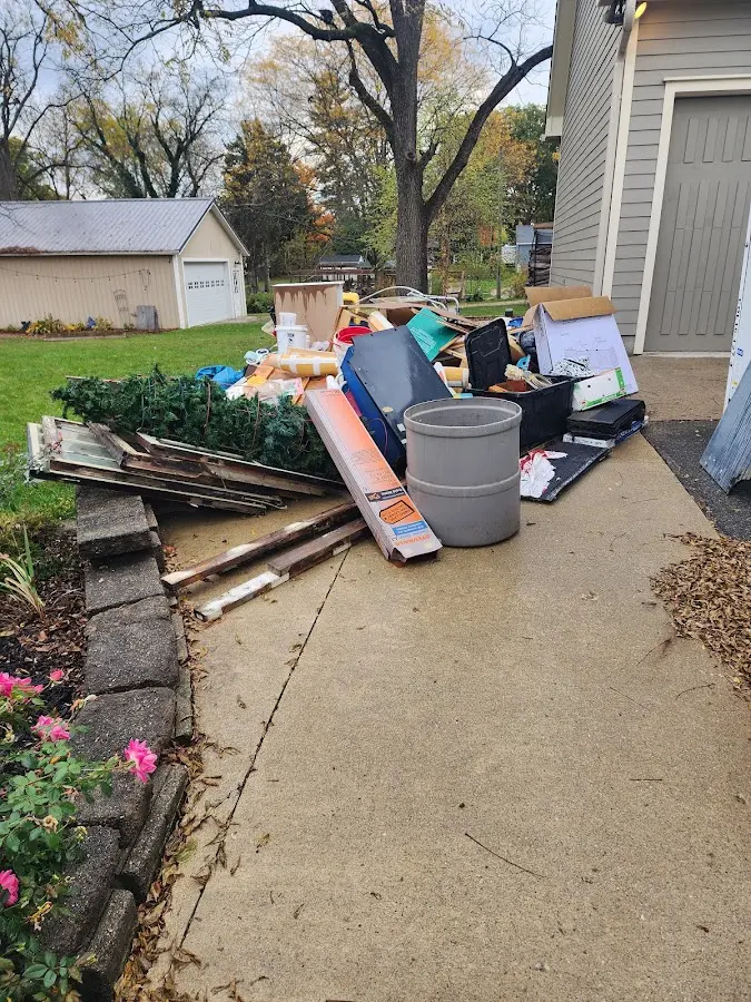 Dumpster being loaded with debris for 12 Yard Dumpster Rental in Bristol
